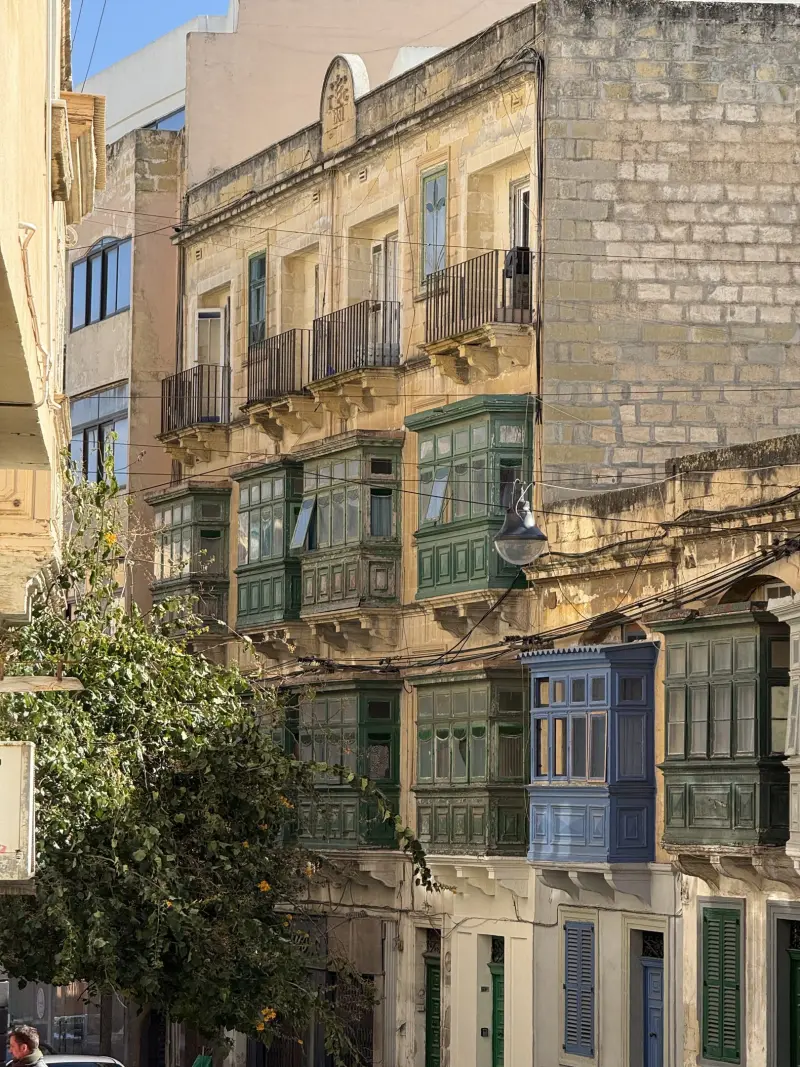 Traditional Maltese townhouses with painted wooden balconies