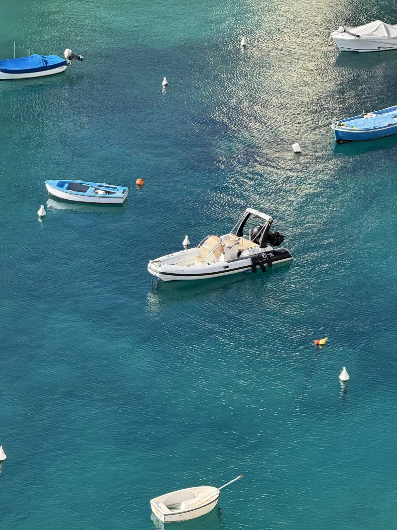 Boats moored in a turquoise Maltese bay
